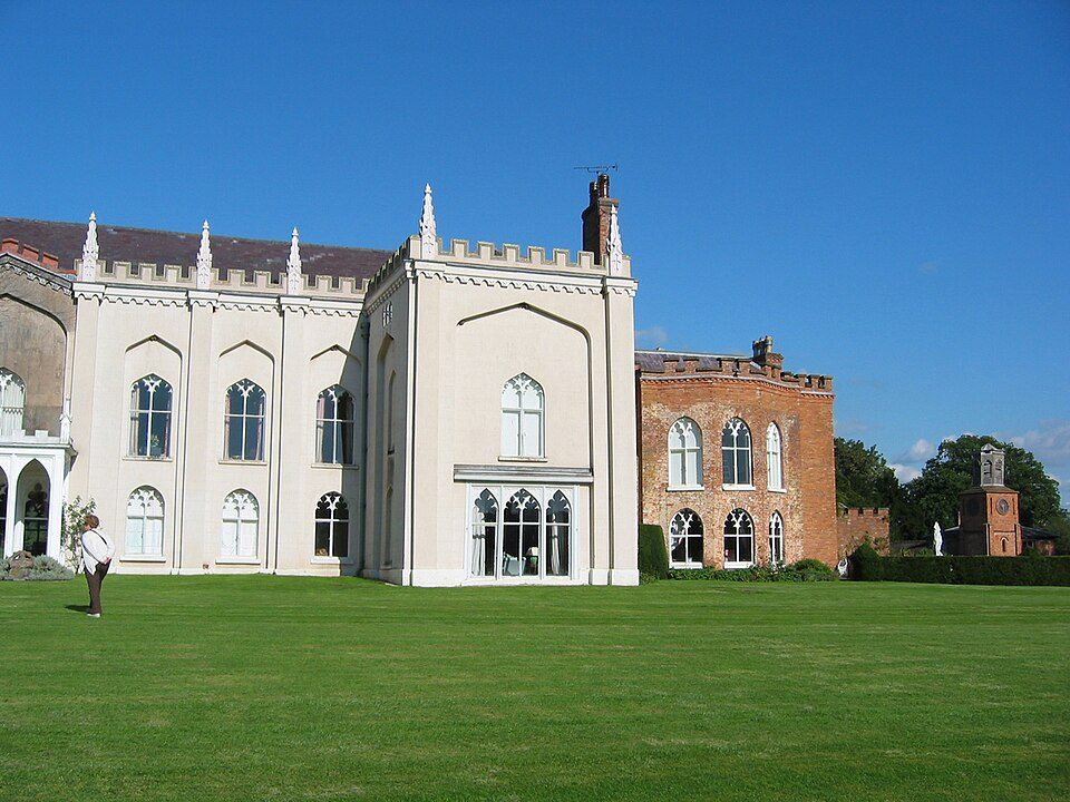 Combermere Abbey's white Gothic-revival front across the lawn