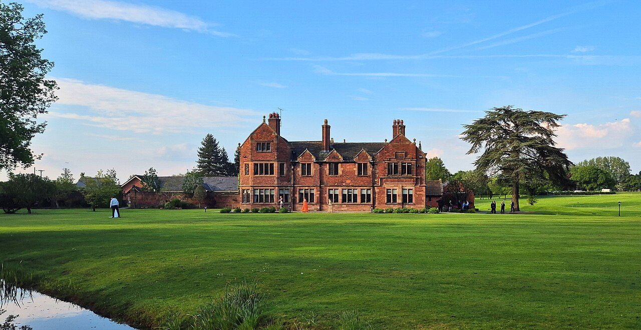 Colshaw Hall's red-brick house set in open parkland